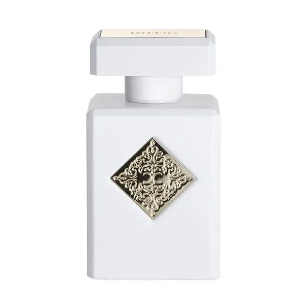 Initio - Hedonist Collection - Musk Therapy eleganter weißer Flakon mit verziertem silberfarbenem Emblem vor hellem Hintergrund